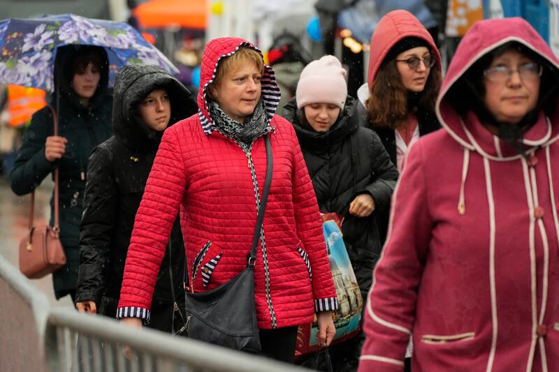 Ukrainian refugees cross the border into Poland.