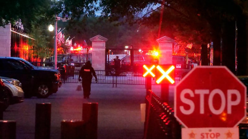 Police are seen outside the White House grounds, Sunday night, July 2, 2023 in Washington.