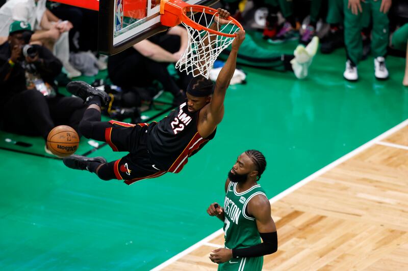 Miami Heat forward Jimmy Butler, left, dunks as Boston Celtics guard Jaylen Brown defends during the second half in Game 7 of the NBA basketball Eastern Conference finals Monday, May 29, 2023, in Boston. (AP Photo/Michael Dwyer)
