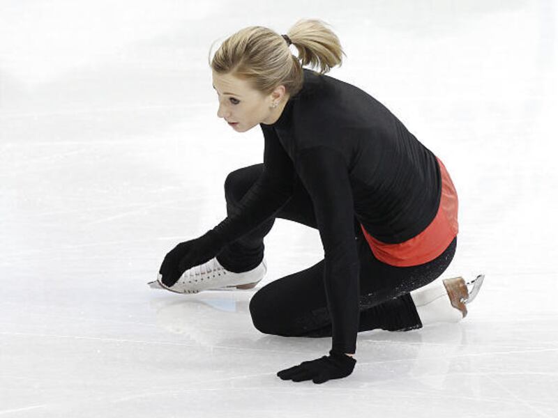 Ladies figure skater Joannie Rochette of Canada falls during a practice session at the Vancouver 2010 Olympics in Vancouver, British Columbia, Sunday. Rochette is practicing, only a few hours after learning of her mother's death.