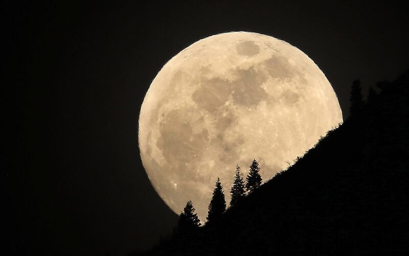 The supermoon rises over Grandeur Peak in Salt Lake City on Jan 30, 2018.