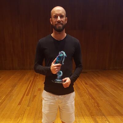 John Graham, a Salt Lake City resident, poses with the seahorse trophy from the 2018 USA Memory Championship. Thirteen competitors participated in the championship, including previous champions.