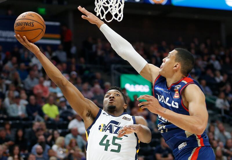 Utah Jazz guard Donovan Mitchell (45) lays the ball up as Adelaide 36ers forward Jake Wiley, right, defends during the first half during an NBA exhibition basketball game Friday, Oct. 5, 2018, in Salt Lake City. (AP Photo/Rick Bowmer)
