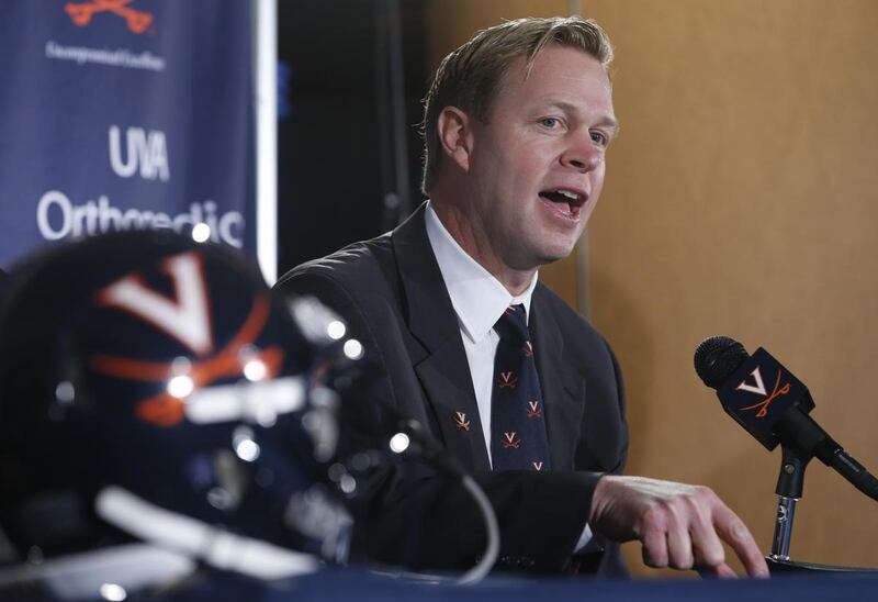 New University of Virginia NCAA college head football coach, Bronco Mendenhall, gestures during a news conference at the school in Charlottesville, Va., Monday, Dec. 7, 2015. Mendenhall takes over after his current team Brigham Young University competes