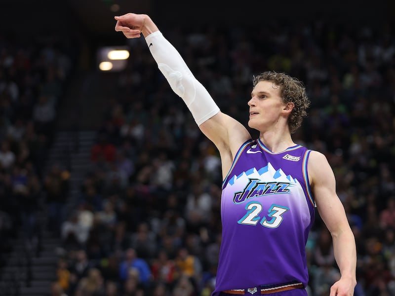 Utah Jazz forward Lauri Markkanen (wearing purple) shoots a 3-pointer