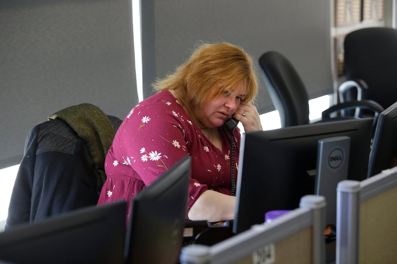 Carolyn Smigla, who has been volunteering at the National Runaway Safeline for 5 years takes a phone call, Friday, March 23, 2018 in Chicago, Illinois. Smigla helps youth, teens, parents and guardians seeking help with runaway victims or victims who are t