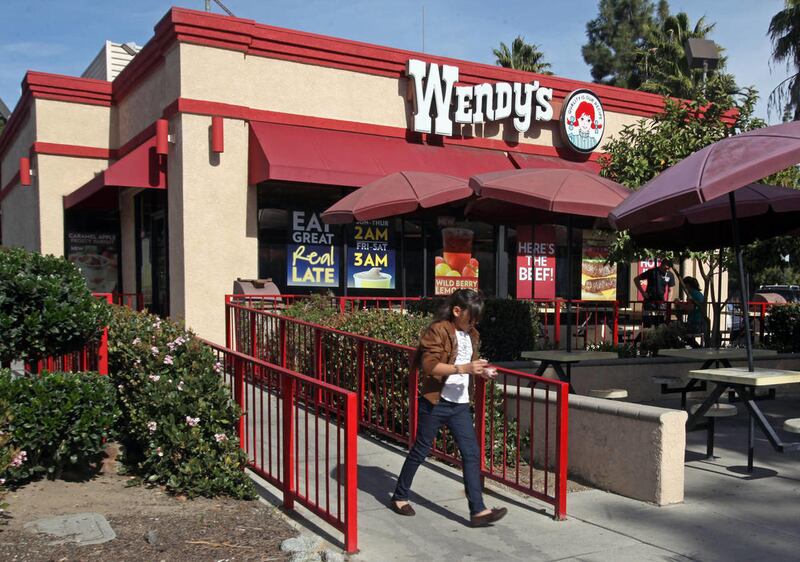 In this Jan. 29, 2012 photo, a customer leaves a Wendy’s restaurant in Los Angeles.