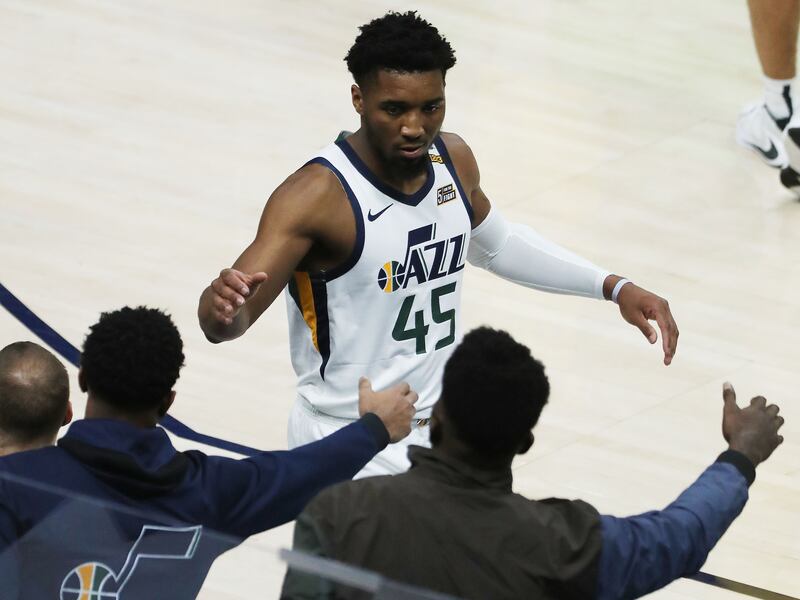 Utah Jazz players give high-fives during an April game in Salt Lake City.