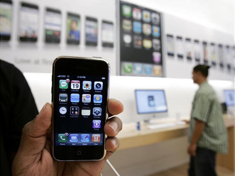 A customer holds an iPhone in October 2007. Other manufacturers are racing to produce touch-screen models.