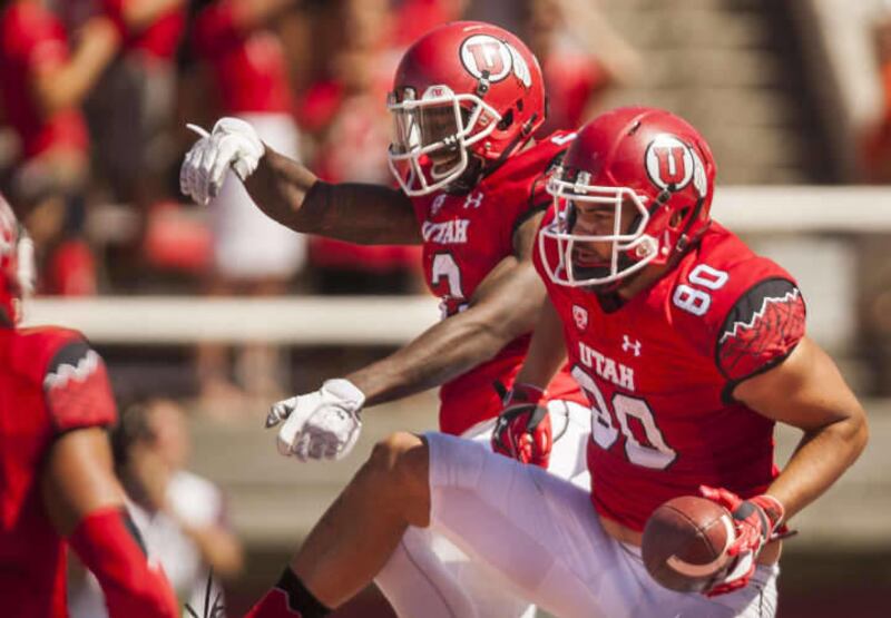 Utah Utes tight end Westlee Tonga (80) and Utah Utes wide receiver Kenneth Scott (2) celebrate after Tonga dove into the end zone for a touchdown during a NCAA football game between the University of Utah and Fresno State at the University of Utah in Salt