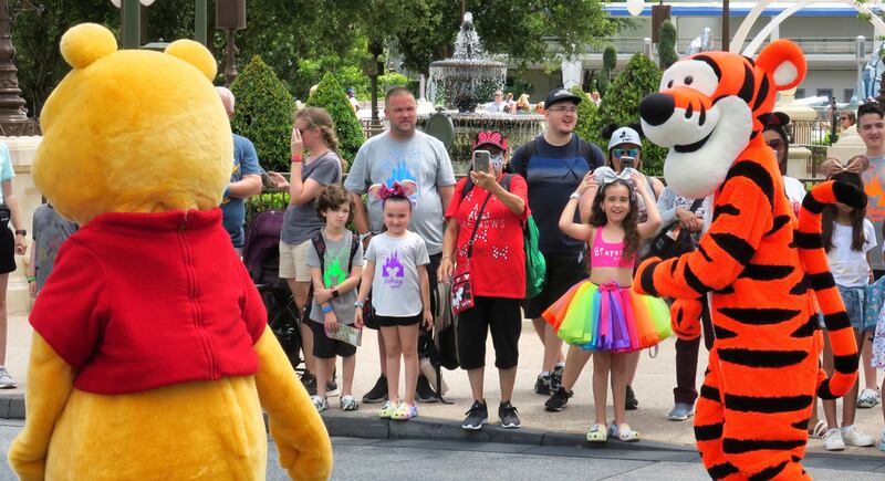Young guests enjoy seeing Winnie The Pooh, and Tigger too, at the Magic Kingdom at Walt Disney World.
