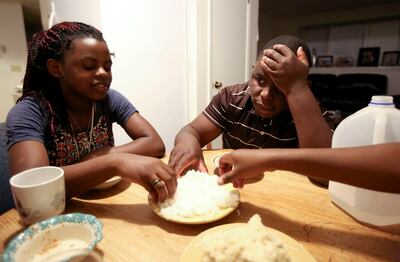 Zulufa Kabuo and her cousin, Ashraf Kambere, eat a late dinner at home in Ogden on Thursday, May 31, 2018.