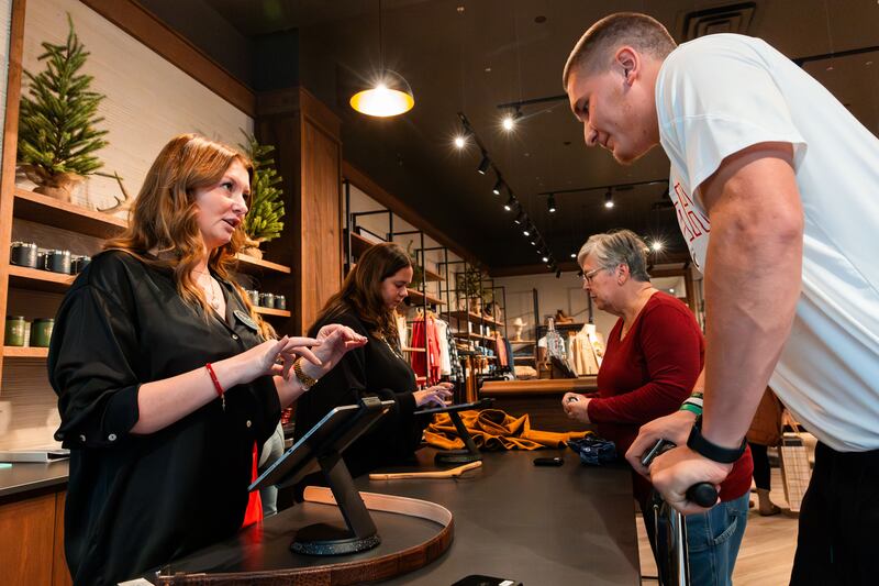 Sydney Vanderheiden checks out Lander Barton on Black Friday at Tecovas at City Creek Center on Nov. 24, 2023.