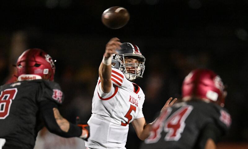 Mountain Ridge’s Wyatt Bingham passes the ball as they and Herriman play at Herriman.