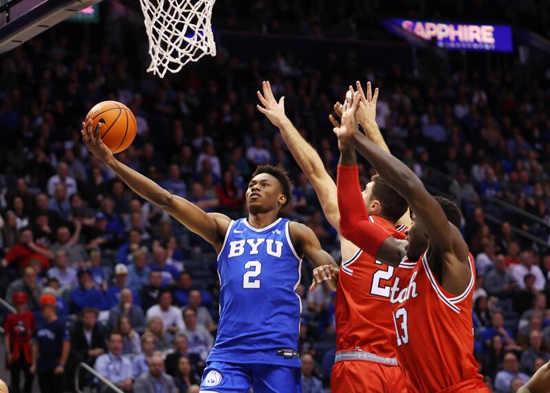 BYU guard Jaxson Robinson lays up a shot against Utah at the Marriott Center in Provo on Dec. 17, 2022.