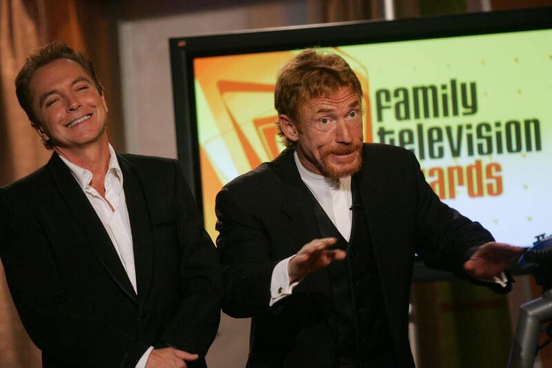 FILE - In a Dec. 1 2004 file photo, David Cassidy, left, and Danny Bonaduce, who played brothers on "The Partridge Family," joke on stage before presenting the award at the annual Family Television Awards in Beverly Hills, Calif. Cassidy and Bonaduce play