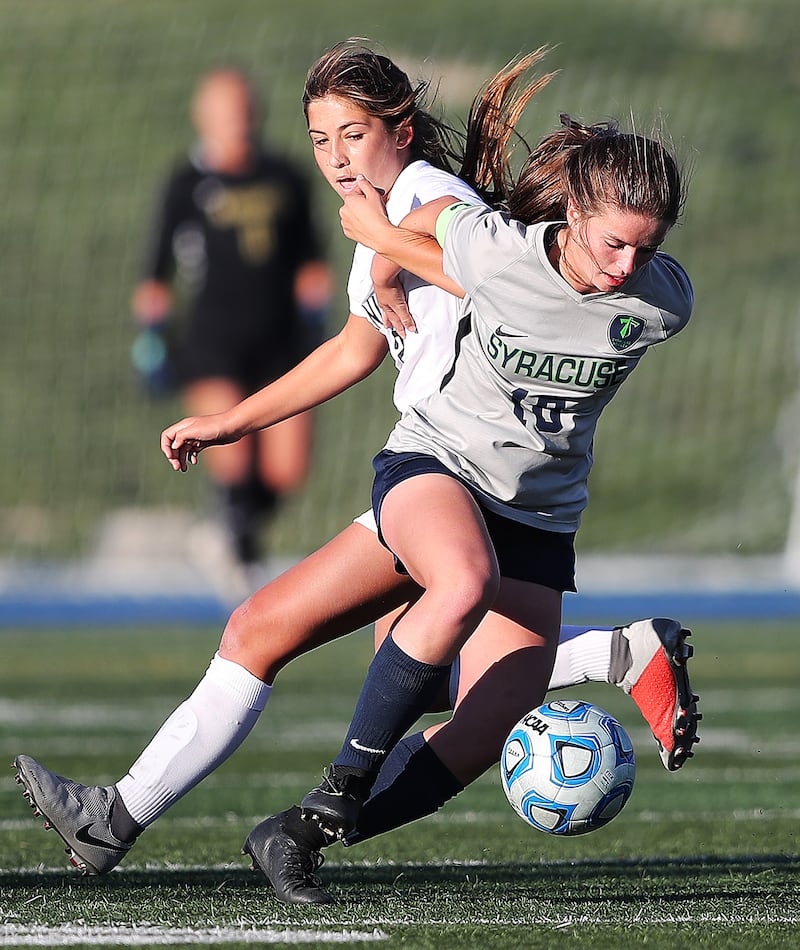 Lone Peak's Isa Irwin works against Syracuse's Caroline Stringfellow as they play in the 6A soccer playoffs at Juan Diego Catholic High School in Draper on Tuesday, Oct. 16, 2018.