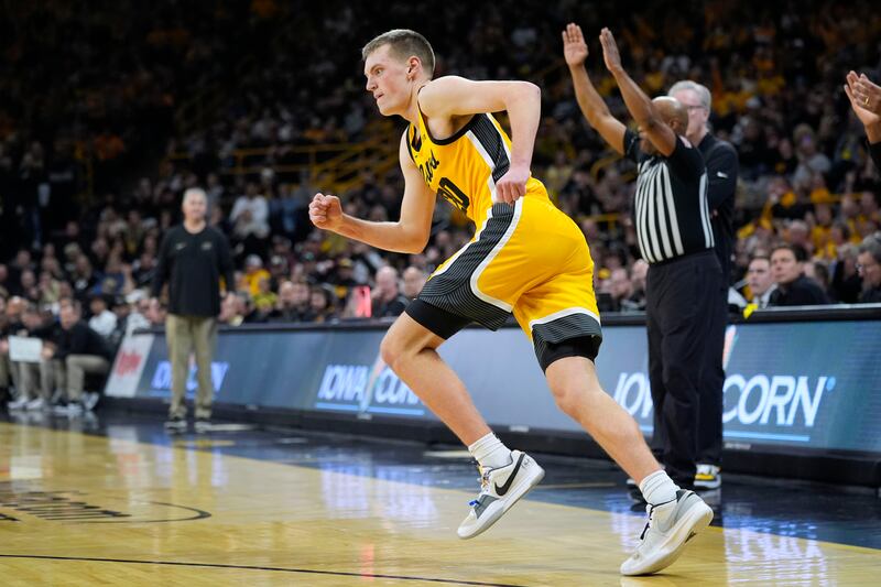 Iowa forward Payton Sandfort (20) runs up court after making a basket during second half of an NCAA college basketball game.
