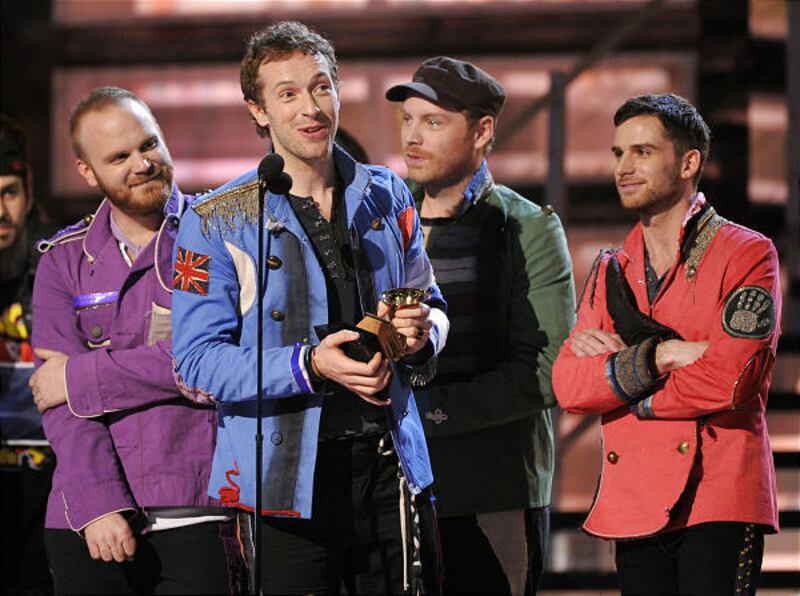 In this Feb. 8, 2009 file photo, Chris Martin, of Coldplay, accepts the award for best rock album at the 51st Annual Grammy Awards in Los Angeles, as bandmates Guy Berryman, left, Jonny Buckland and Will Champion, right, look on.