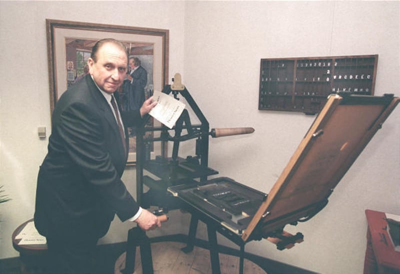 In 1997, President Thomas S. Monson stands with a replica of the first Deseret News press.