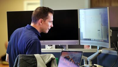 FILE - Travis Scott, of the Utah Department of Public Safety, works at the Utah Cyber Center at the Capitol in Salt Lake City on election night, Tuesday, Nov. 6, 2018.