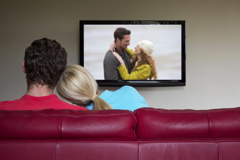 Man and woman watch television.