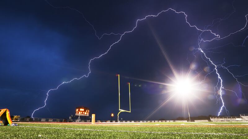 Lightning flashes at halftime as Lone Peak and Herriman open the 2018-19 football season at Lone Peak on Friday, Aug. 17, 2018. The game is delayed at the half for weather.