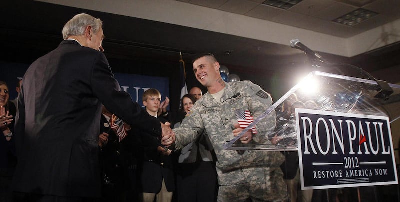 FILE - In this Jan. 3, 2012, file photo, Republican presidential candidate Rep. Ron Paul, R-Texas, left, shakes hands with Cpl. Jesse Thorsen during his caucus night rally, in Ankeny, Iowa. The U.S. Army Reserve announced Friday, March 30, 2012, it has re