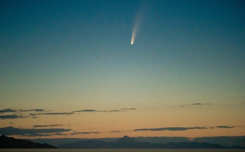 Comet C/2020 F3, also known as NEOWISE, is seen before dawn above the Bonneville Salt Flats.