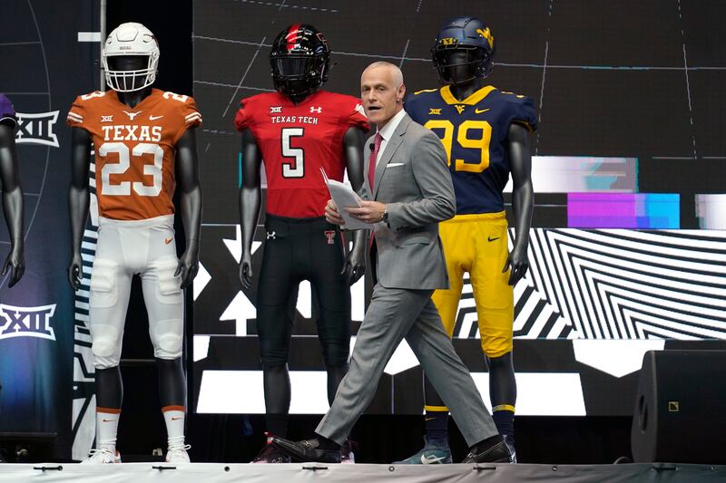Big 12 commissioner Brett Yormark walks on stage to speak at the opening of football Big 12 media days in Arlington.