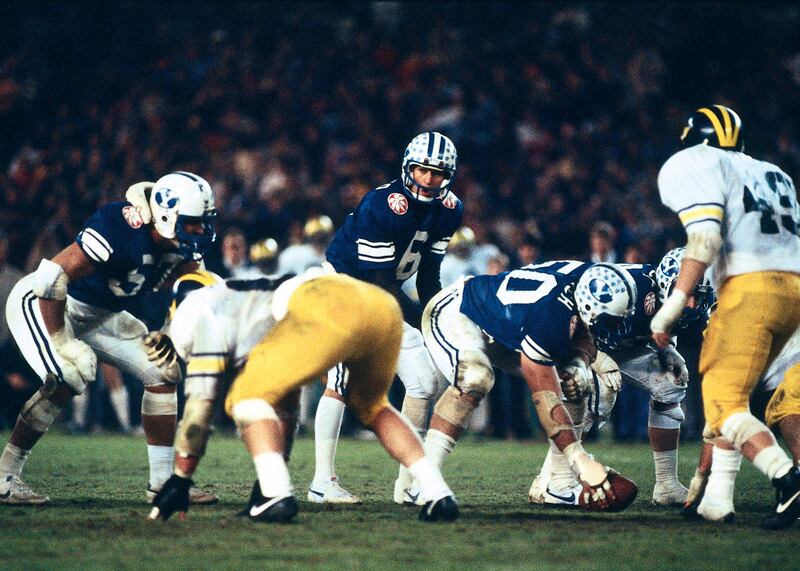 Robbie Bosco prepares to take a snap during game against Michigan at the 1984 Holiday Bowl.