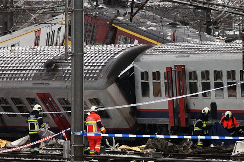 Rescue workers work in and around two passenger trains that collided in Halle, Belgium, Monday. Early reports say up to 20 people may have been killed in a head-on collision between two trains outside the capital, Brussels. Officials say the trains collid