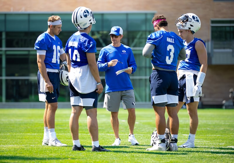 BYU offensive coordinator Aaron Roderick gathers with his QBs during fall camp in Provo.
