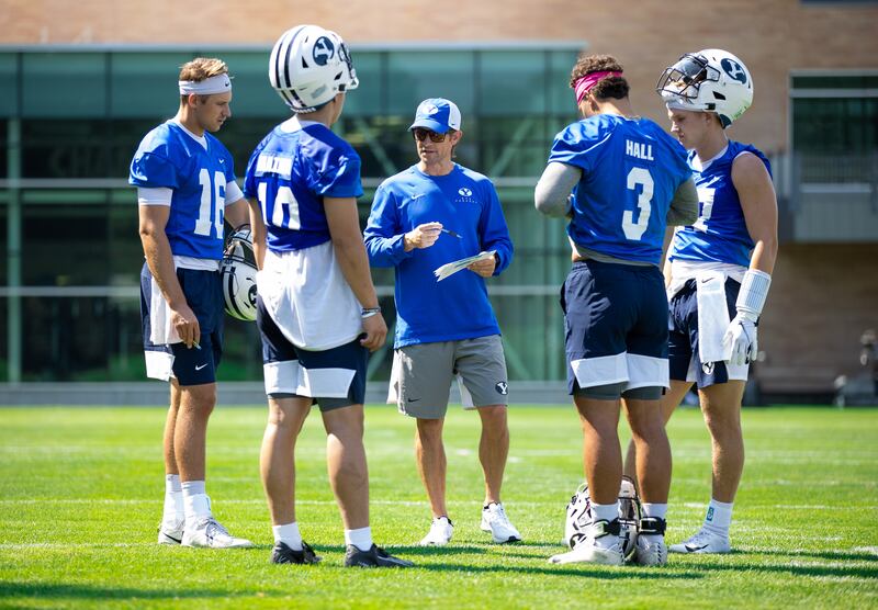 BYU offensive coordinator Aaron Roderick gathers with his QBs during fall camp in Provo.