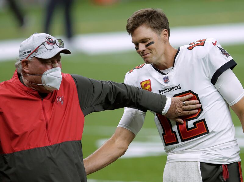 In this Jan. 17, 2021, file photo, Tampa Bay Buccaneers coach Bruce Arians, left, speaks with quarterback Tom Brady before the team’s NFL divisional round playoff football game against the New Orleans Saints in New Orleans. Dr. Anthony Fauci wanted to remind everyone to watch the Super Bowl with their family.