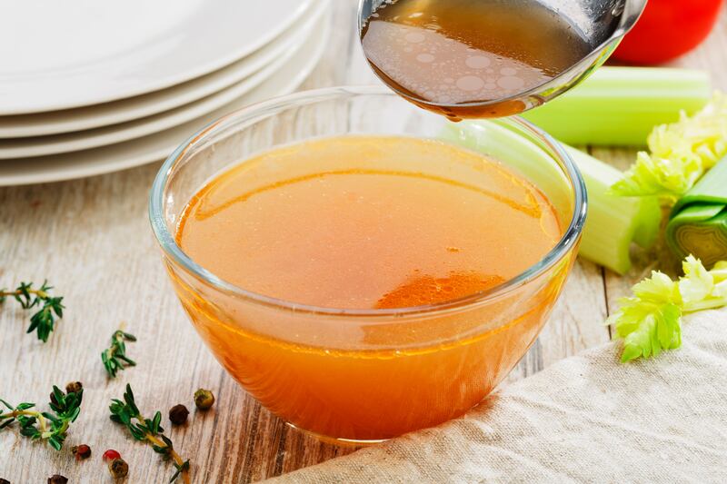 A glass bowl of plain bone broth.