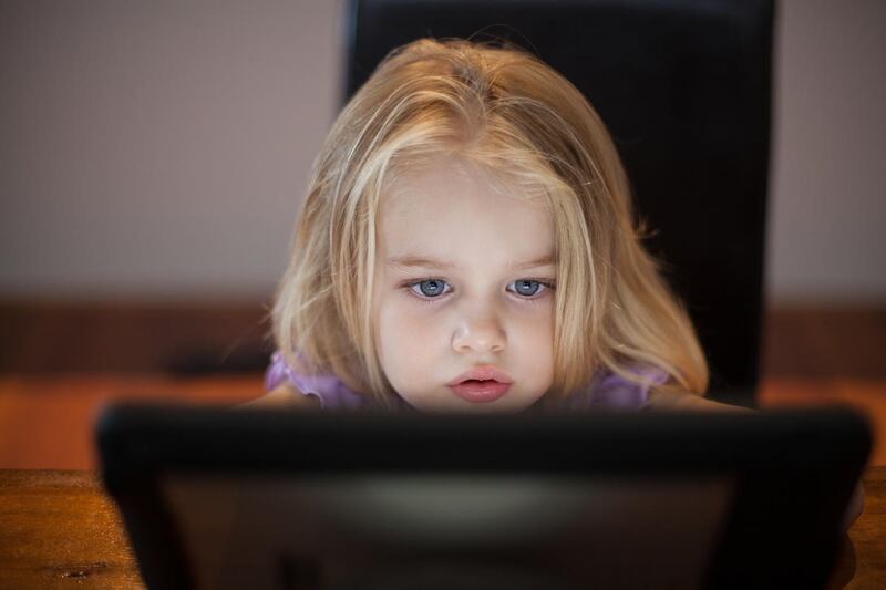 A stock image of a child using an iPad.