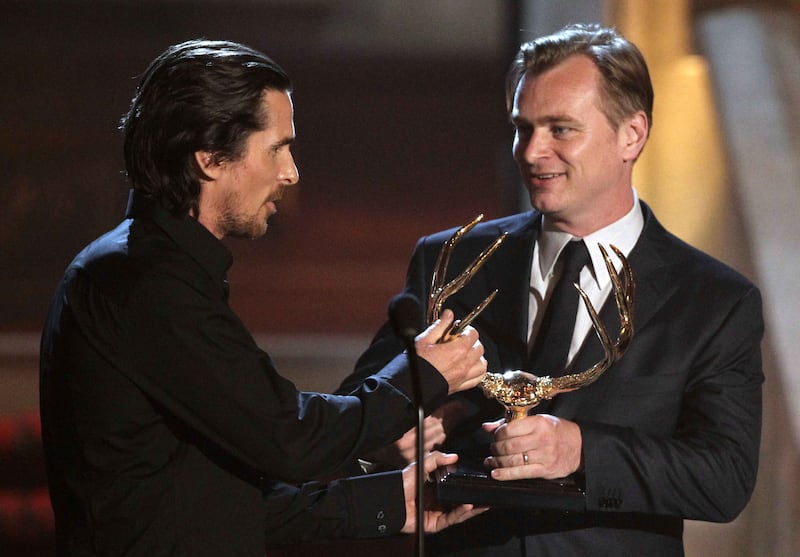 Christian Bale, left, and Christopher Nolan walk onstage to accept an award for “The Dark Knight Rises” at the 2012 Guys Choice Awards on Saturday, June 2, 2012.