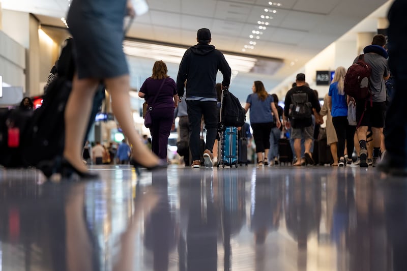 Travelers walk through the Salt Lake City International Airport in Salt Lake City on Aug. 2, 2022.