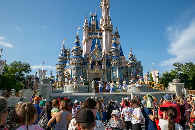Performers dressed as Disney characters entertain visitors at Cinderella Castle at Walt Disney World Resort in Florida.
