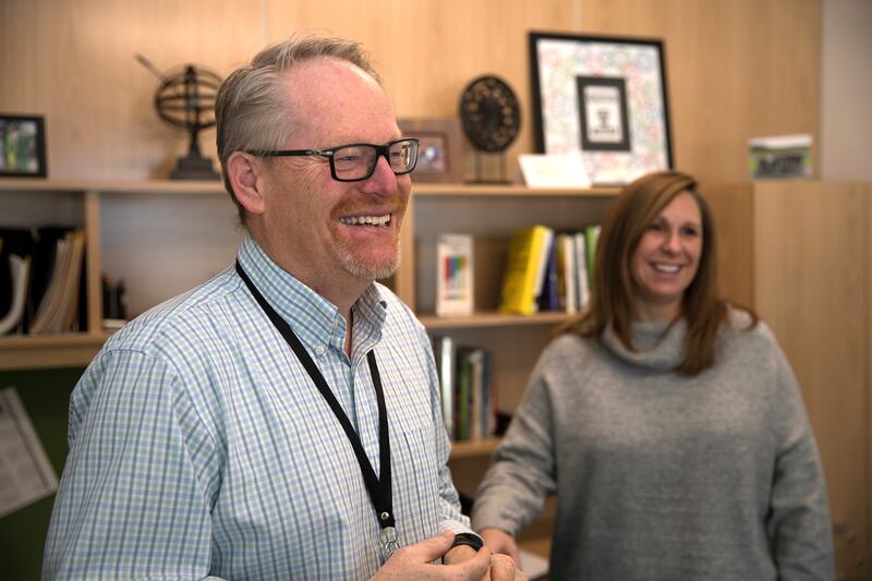 Kevin Ricklefs, senior vice president of Talent Management for CHG Healthcare, left, chats in his office with senior culture specialist Tyra Pounds. For the 10th straight year, CHG Healthcare has made Fortune magazine’s “100 Best Companies to Work For” li