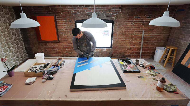 Artist-in-residence Kheng Lim works on a project at Modern West Fine Art in Salt Lake City.
