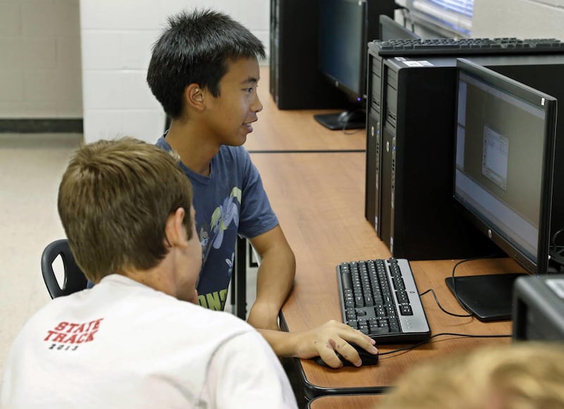 Alex Tu, left, an Advanced Placement Student, works on a computer during a computer science class at Carl Albert High School in Midwest City, Okla., Tuesday, Aug. 27, 2013. Computer science job growth will explode in the next decade, but few U.S. students