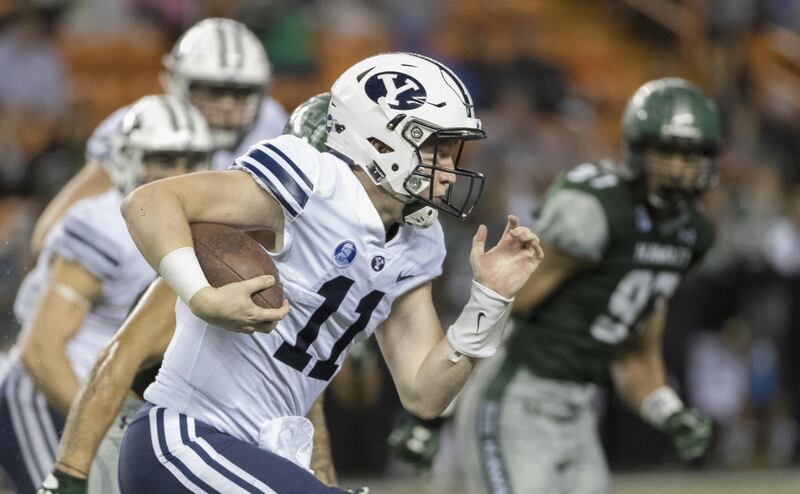 BYU quarterback Joe Critchlow (11) carries the football during the third quarter of an NCAA college football game against Hawaii, Saturday, Nov. 25, 2017, in Honolulu. (AP Photo/Eugene Tanner)