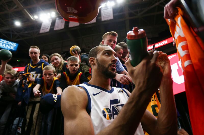 Utah Jazz center Rudy Gobert (27) sings a jersey for a fan after the game with the Minnesota Timberwolves at Vivint Smart Home Arena in Salt Lake City on Thursday, March 14, 2019.