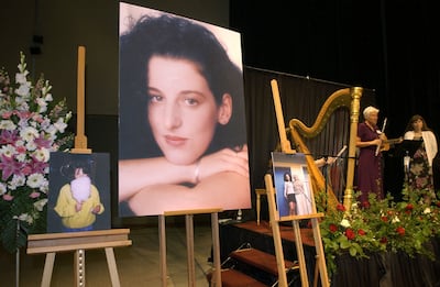 FILE - In this May 28, 2002 file photo, photographs of Chandra Levy are on display as musicians, right, stand by at the memorial service for Levy at the Modesto Centre Plaza in Modesto, Calif. BYU alumnus Peter Stone's new book "The Perfect Candidate" wer