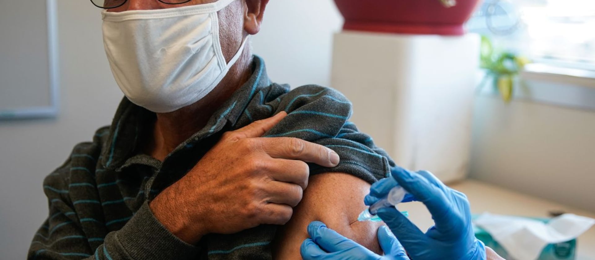 Salt Lake City resident Kim Irwin Pack receives an influenza vaccine at the Salt Lake Public Health Center.