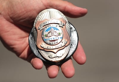 Riverton police officer Mike Ashley shows his badge in Riverton on Friday, June 28, 2019. Riverton started a police department after the city ended its relationship with the Unified Police Department.
