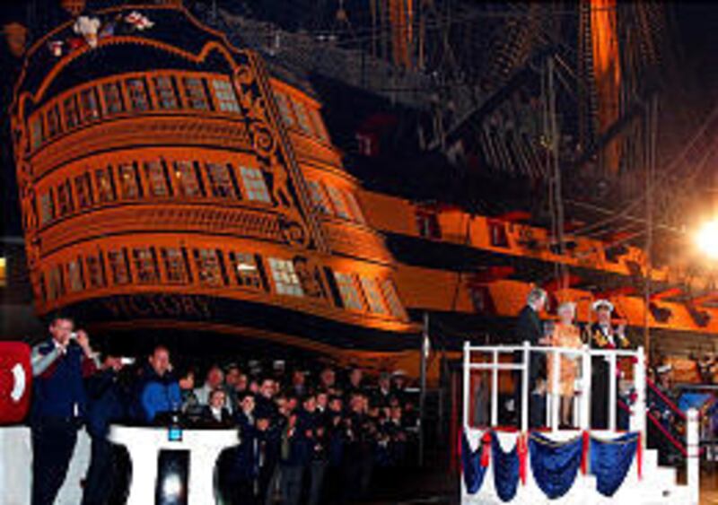 The first Sea Lord, Adm. Sir Alan West, applauds, right, and Bruno Peek looks on as Britain's Queen Elizabeth II lights the Trafalgar Weekend Beacon to mark 200 years since the Battle of Trafalgar, which took place off Cape Trafalgar in southwestern Spain