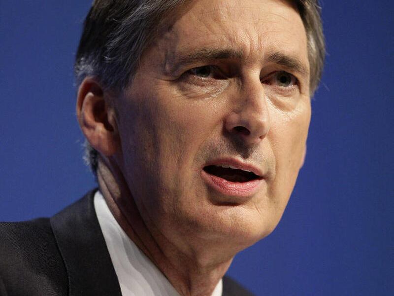 FILE - Philip Hammond, Secretary of State for Transport, speaks at Britain's Conservative Party Conference, Manchester, England, in this Monday Oct. 3, 2011 file photo. Hammond has been named as Britain' s Defence Secretary following the resignation of